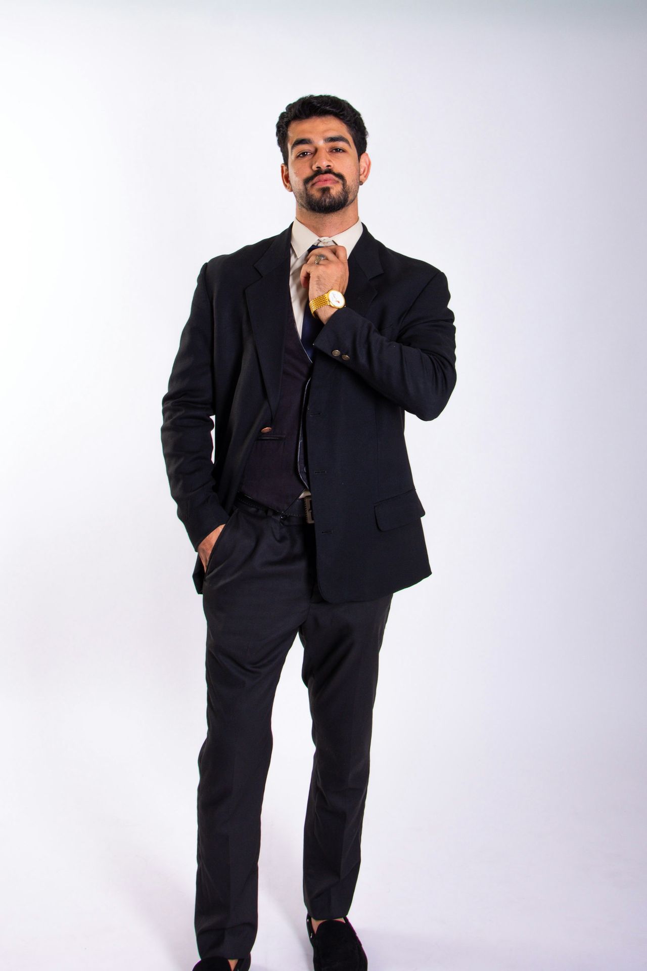 A man in a suit is posing for a picture